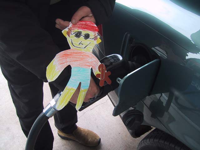 The next morning, we went to breakfast. Flat Stanley helped Ed pump the gas so we could make it the whole way there.