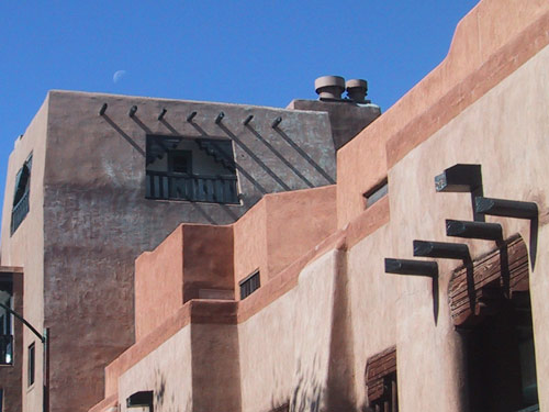 Adobe buildings and moon.